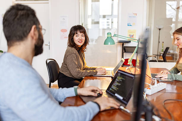 istock Two business colleagues discussing work at startup office space 2237401224