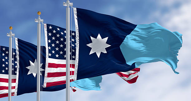istock Minnesota and USA flags waving on a clear day 2237410641