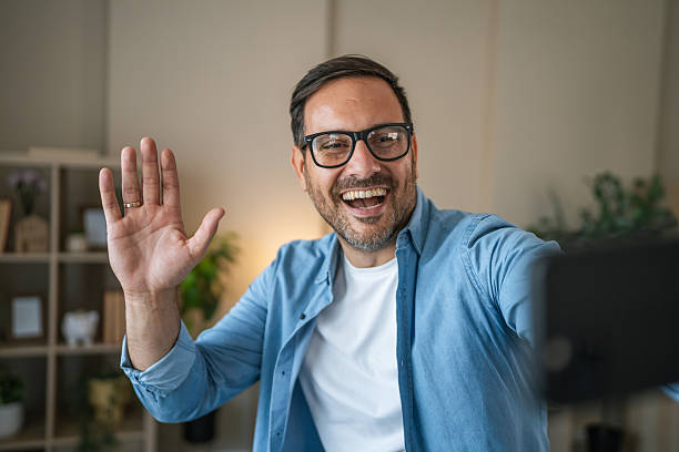 istock Cheerful man taking self portrait with phone at home 2237411389