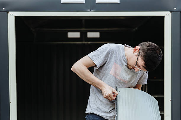 istock A young brunette man removes a protective film from a metal surface. 2237414608