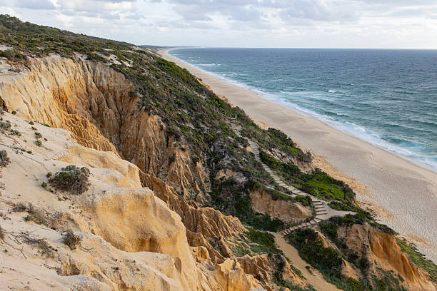 istock A rocky beach with a cliff in the background 2237414992