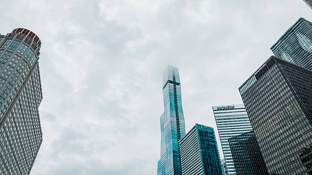 City building pano. Skyscrapers in business district against grey foggy sky. Panoramic view of high-rise office buildings. Panorama cityscape. Long wide banner.