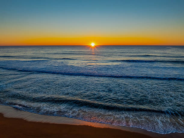 istock Sunrise at the seaside with a cloudless sky 2237428085