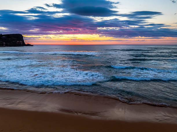 istock Seaside Sunrise Under a Cloud-Filled Sky 2237428108