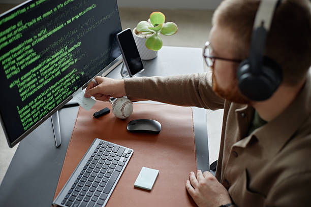 istock Young Adult Man Wearing Headphones Writing Code on Computer Screen 2237436539