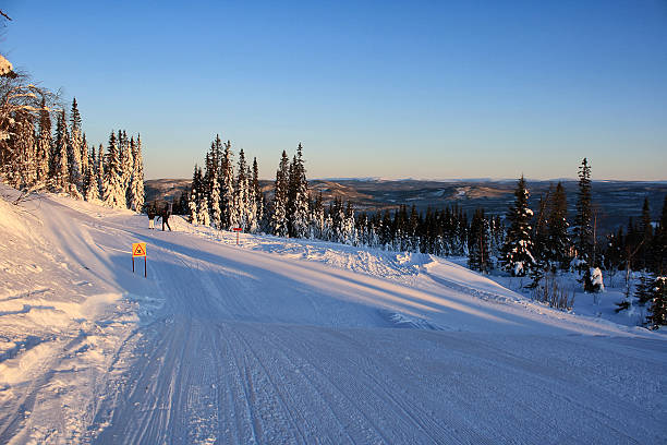 istock Sunrise ski slope with snowy pine trees in Trysil, Norway 2237437778