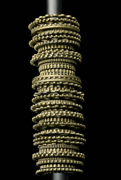 istock Small bronze cogs arranged on top of each other textures and patterns in engineering metal work 2237440222