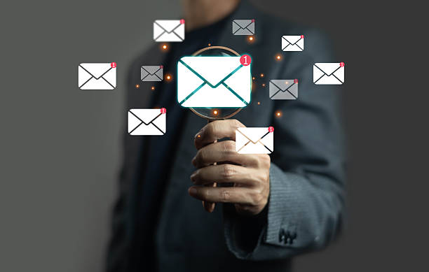 istock Businessman using magnifying glass to focus on new email notification, representing digital communication, email marketing, online service, technology, business network, and corporate connection. 2237440843