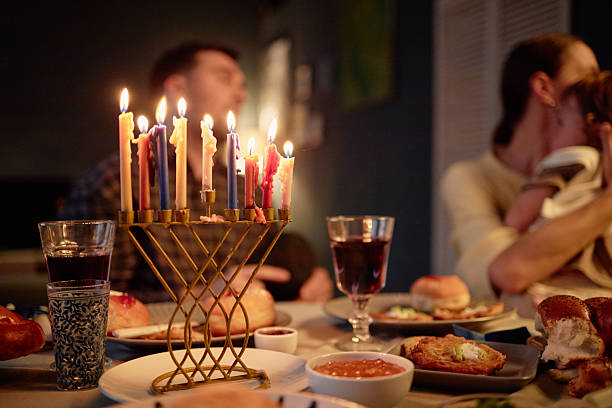 istock Family Celebrating Hanukkah Lighting Menorah during Dinner Gathering 2237440898