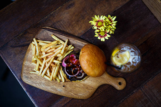 Top Down View of Burger and Fries on Wooden Table