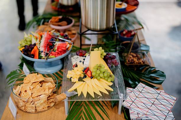 istock Gourmet Buffet Table with Cheese, Fruit, and Crackers On a well Decorated Wooden Table 2237444798