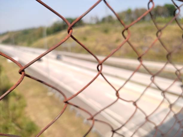 Fence in desert with hole. Concept for illegal immigration. High resolution found on istockphoto.com.