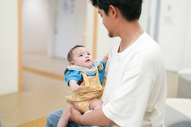 A man is holding a baby in his arms
