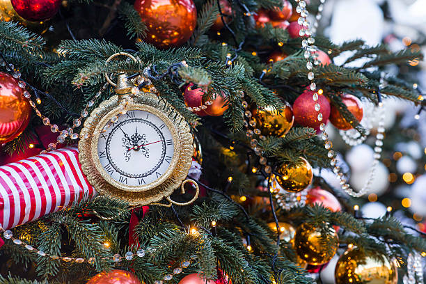 istock The clock hands on the dial show 12 o'clock. Golden retro clock on a Christmas tree. Beautiful background for New Year's Eve or Christmas 2026. 2237452234