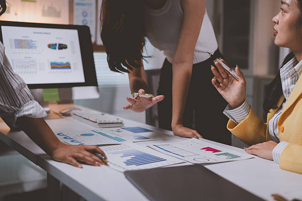 istock Businesswomen analyzing financial data during office meeting 2237455412