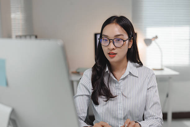 istock Asian businesswoman working on computer in modern office 2237455602