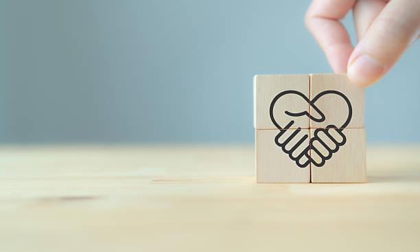 istock Empathy in leadership concept. Wooden block symbolizing trust, empathy and partnership representing individuals, emotional intelligence and trust in workplace leadership and team collaboration. 2237455617
