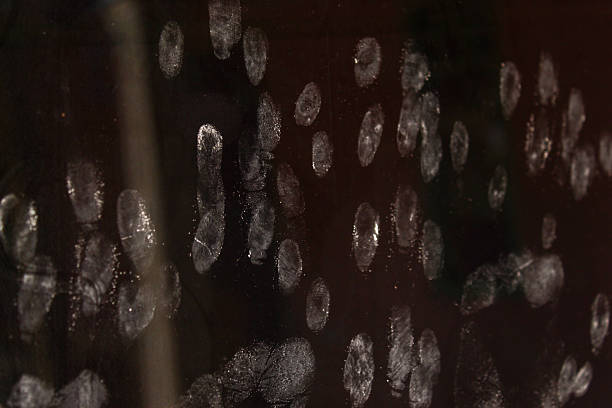 white fingerprints stuck to the black glass surface