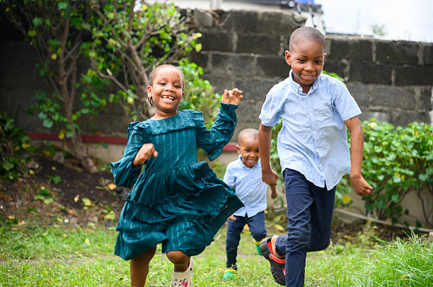istock Three children running outdoors with joyful expressions 2237461801