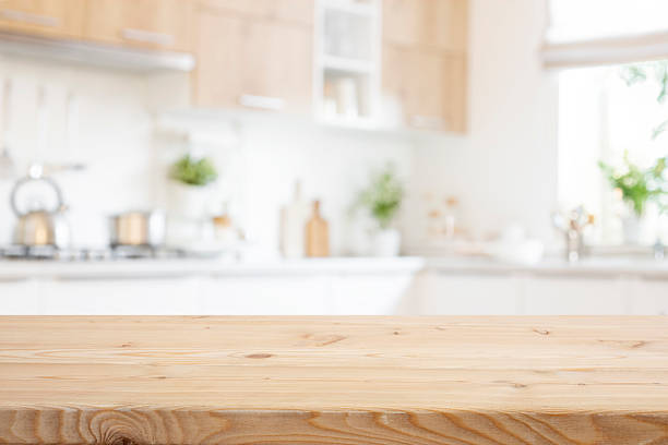 istock Empty wooden table for food presentation with bright blurred kitchen interior background 2237462720