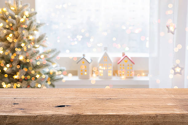 istock Blurred Christmas window with fur tree and decorations in front of aged wooden table background 2237462721