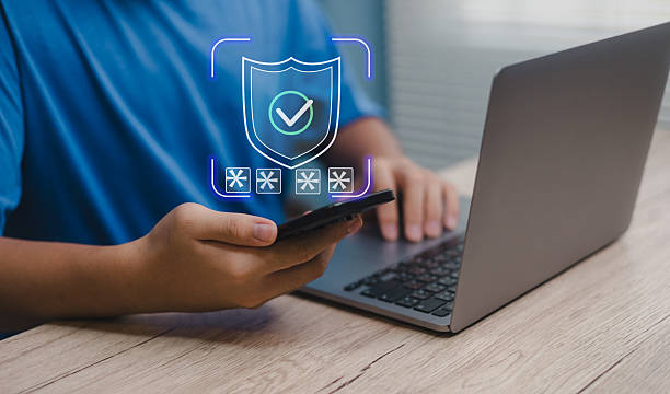 istock Man using smartphone and laptop with digital shield icon, representing cybersecurity, online data protection, secure access, and safe internet banking in modern digital life 2237463031