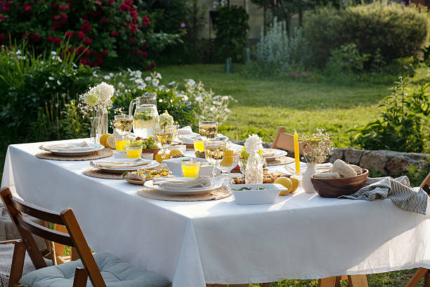 istock Sunlit Outdoor Table Arranged for Summer Breakfast Gathering in Garden 2237468724