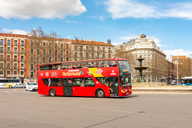 Madrid, Spain - 24 March 2025: Red sightseeing bus on streets of Madrid