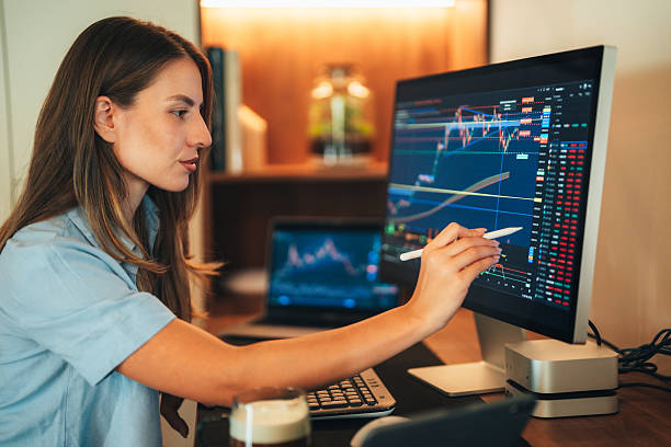 istock Cryptocurrency female trader analyzing market charts on multiple screens 2237470635