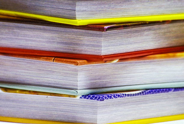 Pile of books with textured covers and soft shadows in a calm setting evoking focus and contemplation