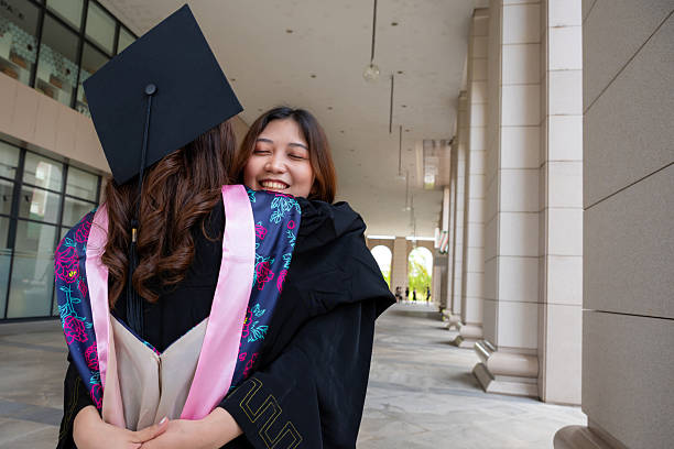 istock Two young female graduates embrace their success 2237472197