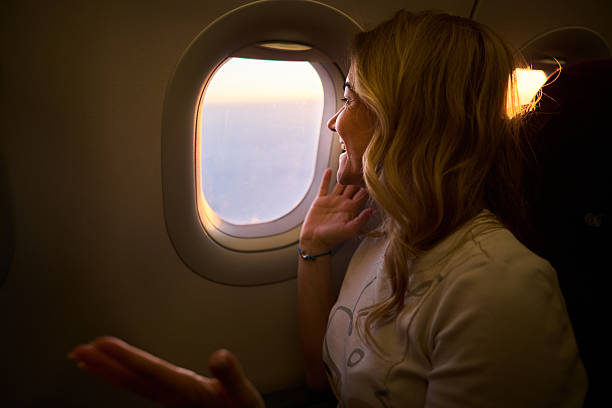 istock Happy woman enjoying while traveling by airplane. 2237472230