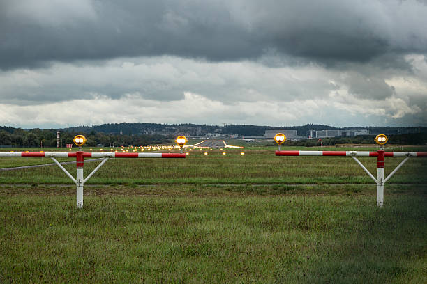 istock Empty airport runway strip with edge lights and precision approach path indicators. Close up, compressed , extreme telephoto shot, cloudy day, no people 2237472534
