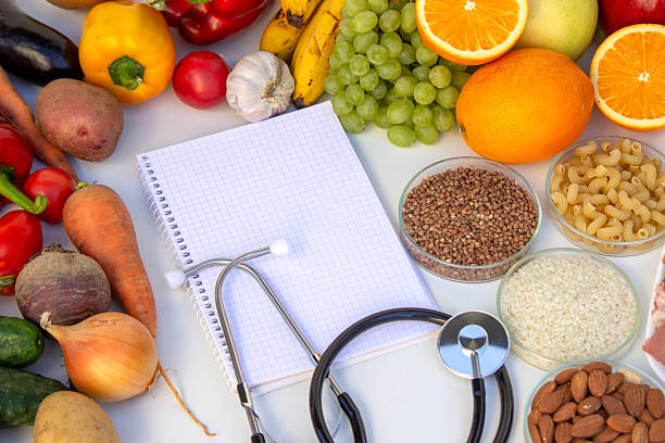 istock Diet Planning: Stethoscope, Notebook, and a Balanced Selection of Food 2237473451