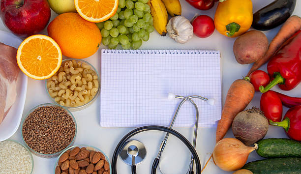 istock Diet Planning: Stethoscope, Notebook, and a Balanced Selection of Food 2237473463