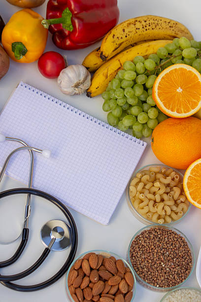 istock Diet Planning: Stethoscope, Notebook, and a Balanced Selection of Food 2237473466