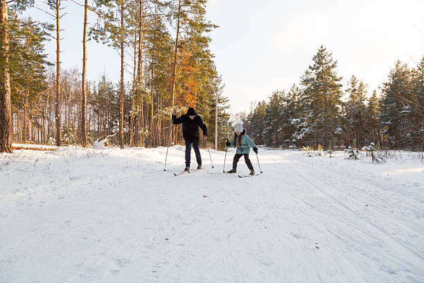 istock Dad and daughter skiing in the winter forest 2237474023