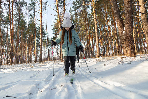 istock Dad and daughter skiing in the winter forest 2237474065