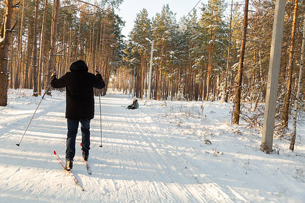 istock Dad and daughter skiing in the winter forest 2237474083