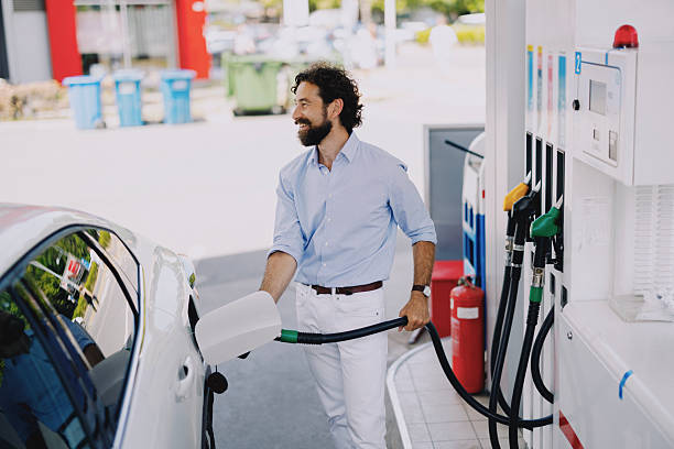istock Middle-aged man refueling his car at gas station 2237475437