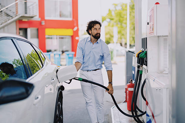 istock Middle-aged man refueling his car at gas station 2237475468