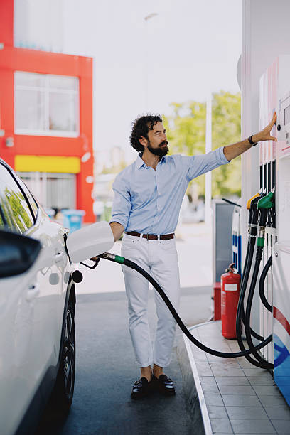 istock Middle-aged man refueling his car at gas station 2237475502
