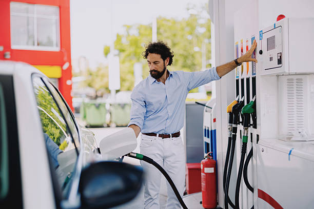 istock Middle-aged man refueling his car at gas station 2237477678