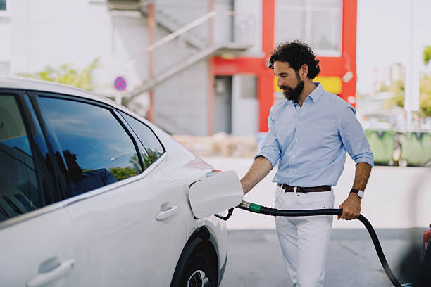 istock Middle-aged man refueling his car at gas station 2237477729