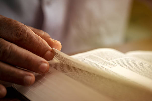 istock Close-up senior male reading book at home. 2237480352