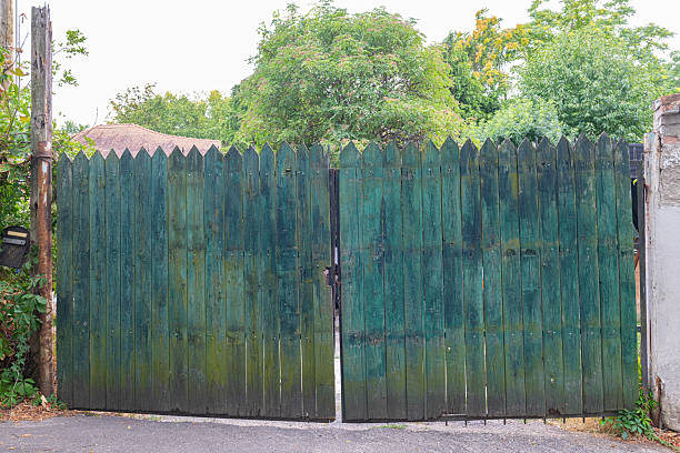 istock An old, green-blue wooden fence or gate. Rustic and natural text 2237484499