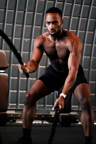 istock Muscular Man Training with Battle Ropes at Gym 2237486513