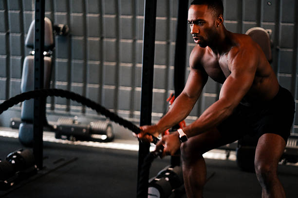 istock Muscular Man Training with Battle Ropes at Gym 2237486573