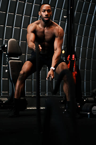istock Muscular Man Training with Battle Ropes at Gym 2237486774