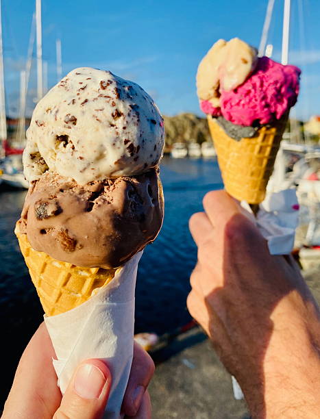 istock Two hands holding colofrul ice cream cones 2237487902